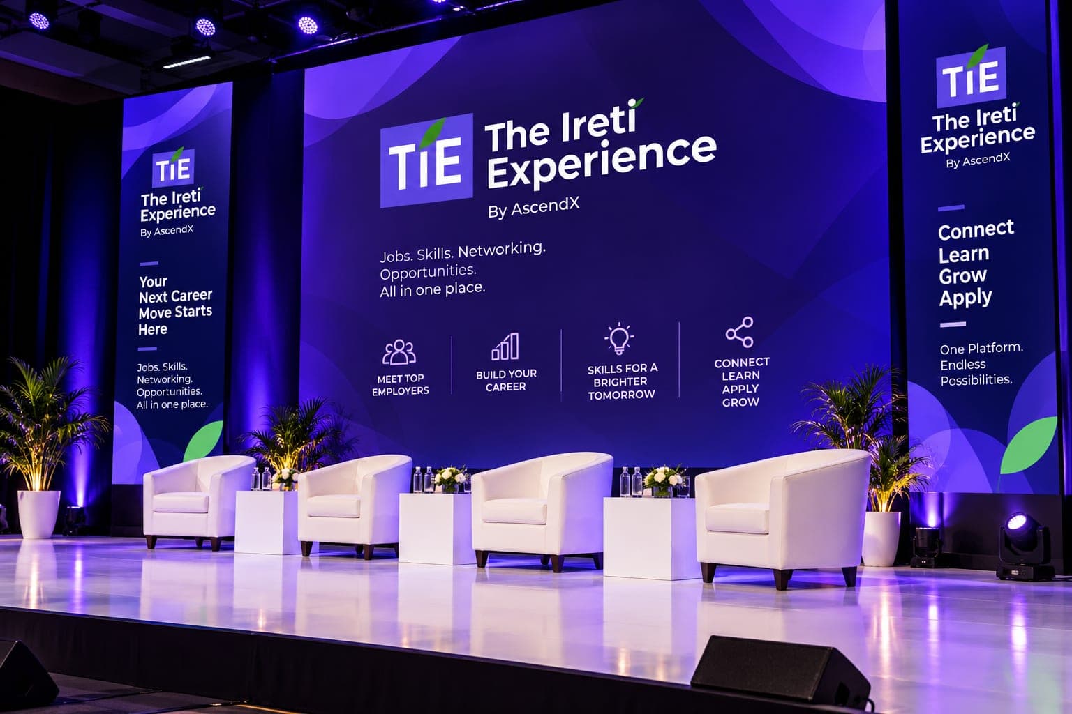 The T.I.E stage set with four white lounge chairs in front of a large The Ireti Experience screen